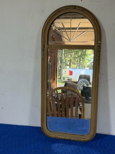 antique-style wall mirror features a gold-finished, ornate gesso frame with a classic arched top