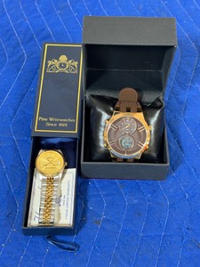 Gunderson Lake Conference Watch (has hockey sticks on it and states a name on the back) & Axiom Quartz Watch