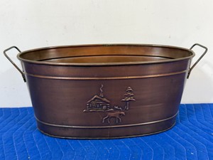 embossed copper-plated oval beverage tub with cabin, moose and pine tree displayed on the outside