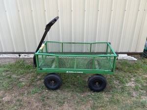Gorilla Carts branded steel garden cart featuring a green mesh bed and 10-inch pneumatic tires