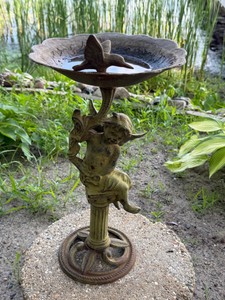 vintage-style ornate cherub cast iron birdbath.