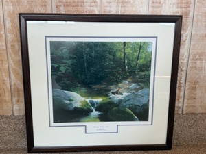 framed art print titled Where Paths Cross by artist Nancy Howe features a detailed depiction of a blackbird at a stream.