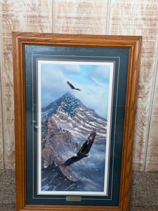 Franed art print titled On Freedoms Wing by artist Rick Kelley, featuring eagles soaring over a mountain peak.