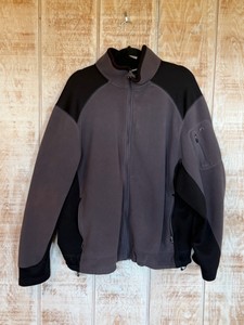 Full-zip fleece jacket features a two-tone black and gray design with a zippered pocket on the left arm - Looks like it XL  Large - Does have some marks in front but not very visible
