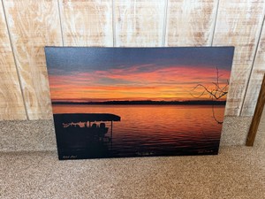 Framed artwork appears to be a canvas print featuring a silhouetted boat dock against a vibrant orange and yellow sunset - Artist Proof - The Golden Hour - Signed by artist