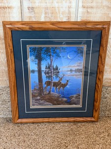Framed artwork is Nightcap by artist Darrell Bush, featuring a buck and doe by a lake under a crescent moon.