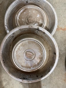 Two Cadillac Hubcaps