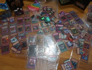 LARGE LOT  OF YUGEEOH CARDS, BOARD AND CHARM BRACELET