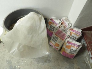 5 BAGS AND GARBAGE CAN FULL OF CEMENT TILE GROUT