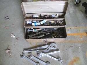 Vintage metal toolbox with assortme...