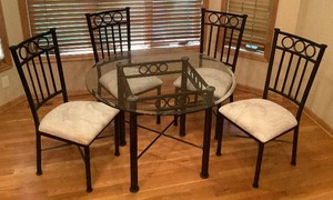 Black Metal and Glass Top Round Dining Table with Four Cushioned Chairs