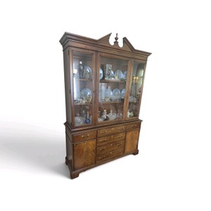 Mahogany china cabinet featuring a broken pediment top and glass-fronted display doors