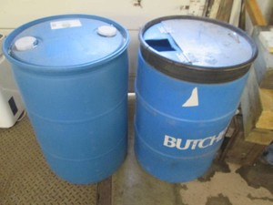 2 Plastic drums, one has a hinged m...