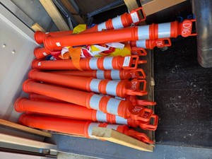 BUNDLE OF ORANGE DELINEATOR TUBES AND BASES