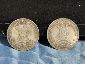 2 - modern replica tokens modeled after an experimental William Barber pattern design for the United States Trade Dollar.