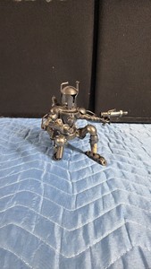 handcrafted scrap metal figurine inspired by Boba Fett or a Mandalorian warrior from Star Wars