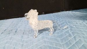 Hand-blown art glass lion figurine potentially featuring a spun glass or lacey textured body