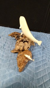 Vintage John Perry sculpture featuring a whale, likely a beluga made from Pellucida resin mounted on a natural burl wood base and a smaller one