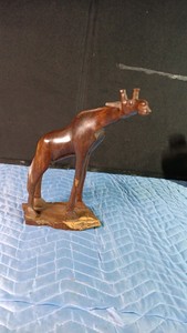 Wooden giraffe on wood base