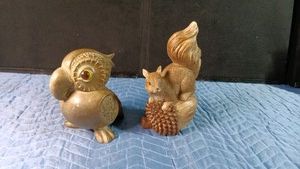 resin squirrel and a ceramic parrot