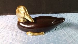 Vintage Enesco wooden duck decoy featuring a polished brass head