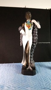 an imported statue of a lady with a parrot on her chest