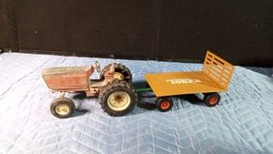 Vintage Ertl International Harvester toy tractor of die-cast metal and a Tonka hay wagon