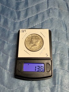 1964 Kennedy Half Dollar featuring John F. Kennedy on the obverse.