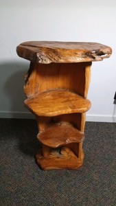 4tier shelf made out of tree slabs and half a log bored out