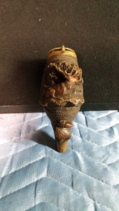 Carved hunting powder flask carved from a coquilla nut from a Brazilian palm tree and has a German silver lid
