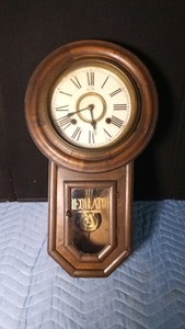 Vintage Regulator A wall clock, often styled as school clock manufactured by Owari Clock Co. with key