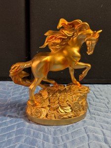 Golden Feng Shui Wealth Horse Statue, a decorative sculpture often used to symbolize prosperity, success, and rapid career advancement