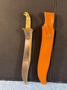 vintage style Bowie knife with sheath, featuring distinctive design elements characteristic of historical and replica American hunting blades - see description for more info