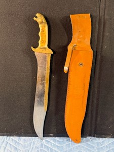 vintage style Bowie knifewith sheath, featuring distinctive design elements characteristic of historical and replica American hunting blades - see description for more info