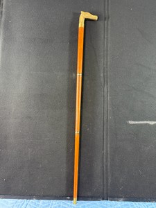 Vintage collapsible wooden walking cane featuring a solid brass horse head handle