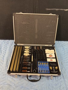 Gunmaster Deluxe Universal Gun Cleaning Kit, an all-in-one firearm maintenance set safely organized inside a durable aluminum carrying case.