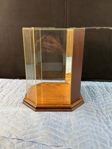 Vintage octagonal glass and wood tabletop display case, often used for collectibles, figurines, or dolls