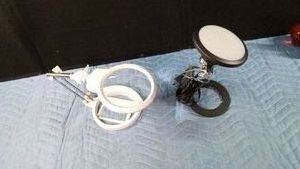 Battery operated magnifying light and an electric lamp on light