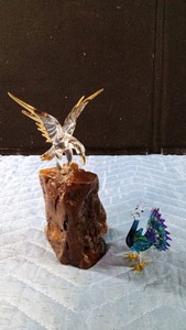Glass Baron eagle figurine accented with 22K gold on burl wood and a hand-blown glass peacock
