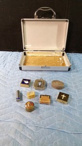 Vintage pill boxes, vintage Savage Flame lipstick made in US, and a vintage compact in a mel small suitcase