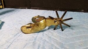 Vintage brass spur with floral design