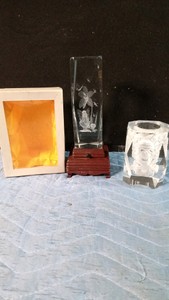 Beveled crystal glass paperweight featuring a 3D laser etched fairies, flower and dragonflies and a crystal candle holder featuring a 3D laser etched skull.