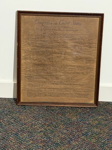 Framed document is an antiqued parchment replica of the United States Bill of Rights.