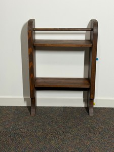 Wooden shelf or blanket rack featuring a dark stain finish, two open flat shelves, and a smooth top support dowel.