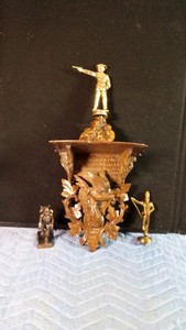 2 Trophies, Alaska pioneer statue and a wooden shelf with bird