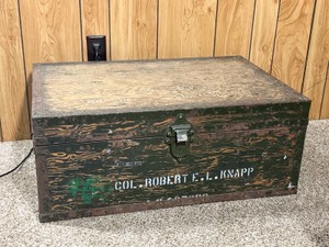 Vintage U.S. military footlocker trunk, historically used by officers and enlisted personnel to store and transport their personal gear, uniforms, and equipment while deployed or stationed at a base.