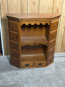 vintage wooden storage cabinet features a scalloped shelf detail, dual side cabinet doors, open middle shelving, and a pull-out bottom double-drawer - see description for more info