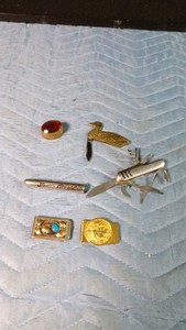 Theodore Rosevelt bullet pendent, knives, pill box and money clips