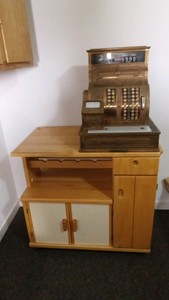 Vintage National brass cash register and wood wine cabinet