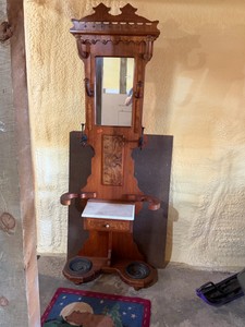 Victorian-era hall tree constructed from carved walnut and featuring a central mirror